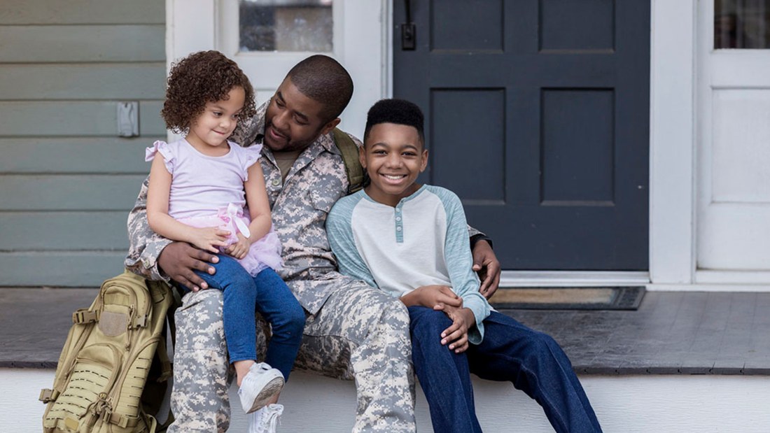 Service member home with his children on the porch of a Sioux Falls house