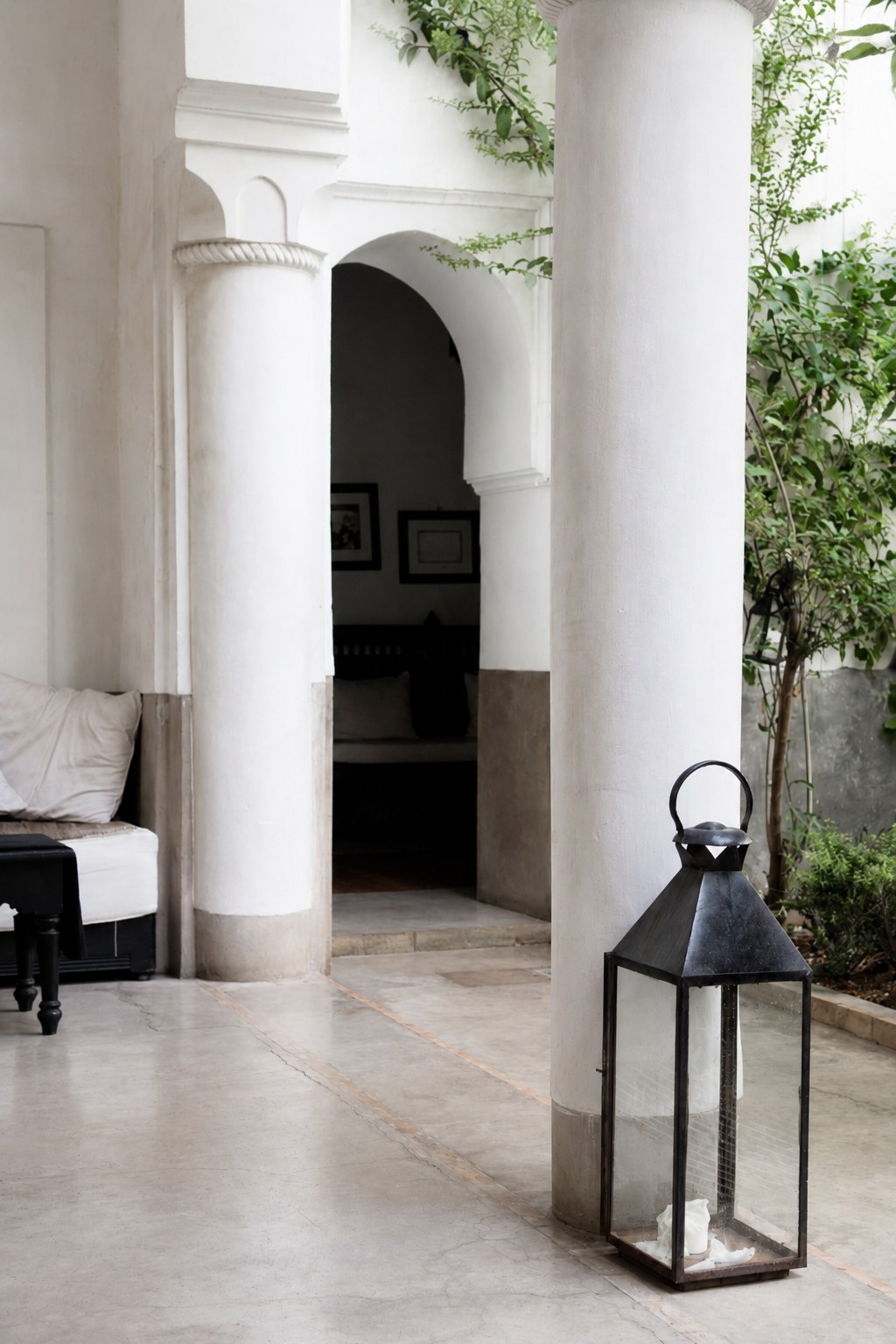 Elegant white courtyard with arched doorway and lantern, reflecting the refined brand identity design style of The Agency in Sioux Falls